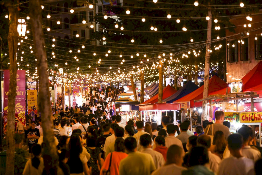 The colorful light decoration creates a lively, welcoming festive atmosphere throughout the market 